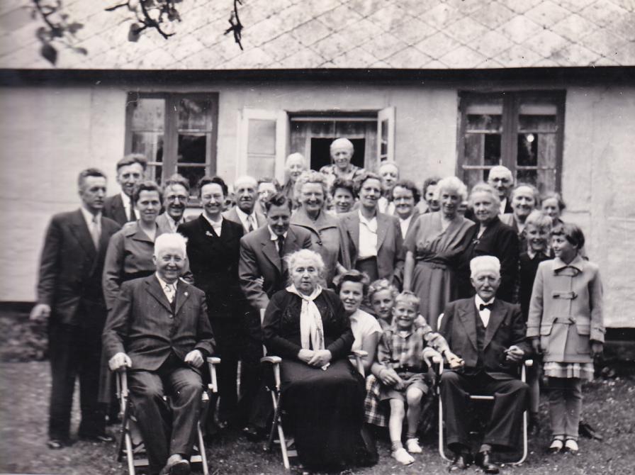 Sort-hvid foto af en stor flok mennesker opstillet til foto udendørs.